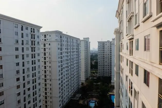 Monochrome Style 2 Bedrooms at Kalibata City Apartment By Travelio