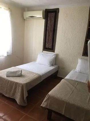 Two Individuals Beds with AC & Fan Shared Bathroom