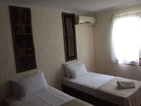 Two Individuals Beds with AC & Fan Shared Bathroom