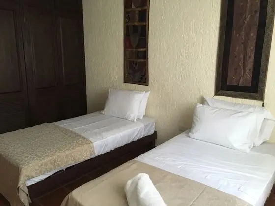 Two Individuals Beds with AC & Fan Shared Bathroom