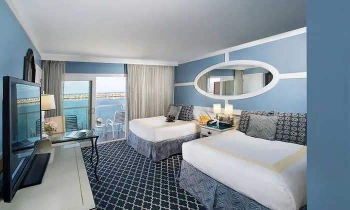 Room with Two Double Beds and Partial Ocean View